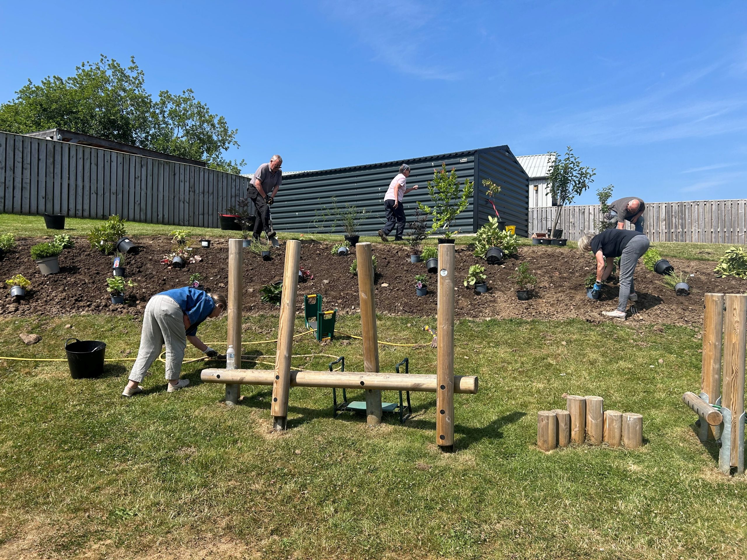 Gardening volunteers planting a new garden bed at The Steading in Rosewell.